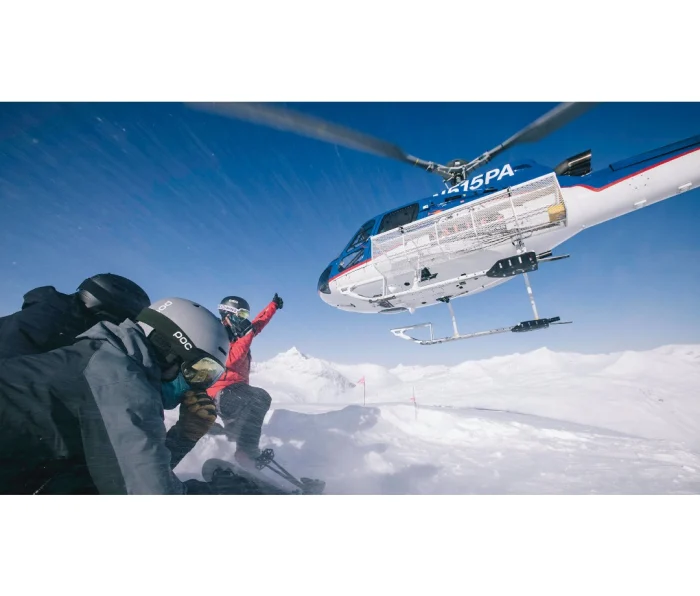 A helicopter perched on a ridge in the Chugach Mountains, Alaska