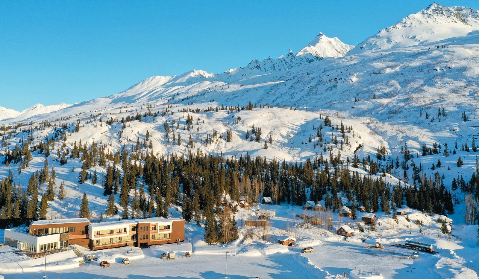 Aerial drone view of the Tsaina Lodge with the Chugach Mountains behind it, Thompson Pass, Alaska