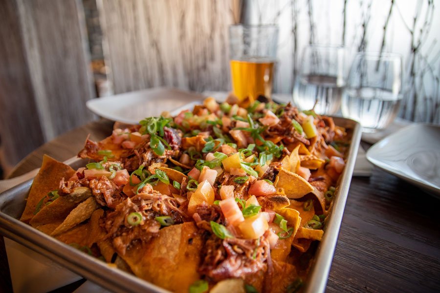A large plate of nachos and a beer at the Tsaina Lodge bar
