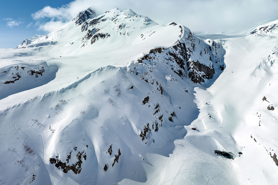 Scenic aerial view of Worthington Glacier and its natural ice cave near Tsaina Lodge in Valdez, Alaska, highlighting the breathtaking Chugach Mountain glacier landscape just steps from the base of Valdez Heli-Ski Guides